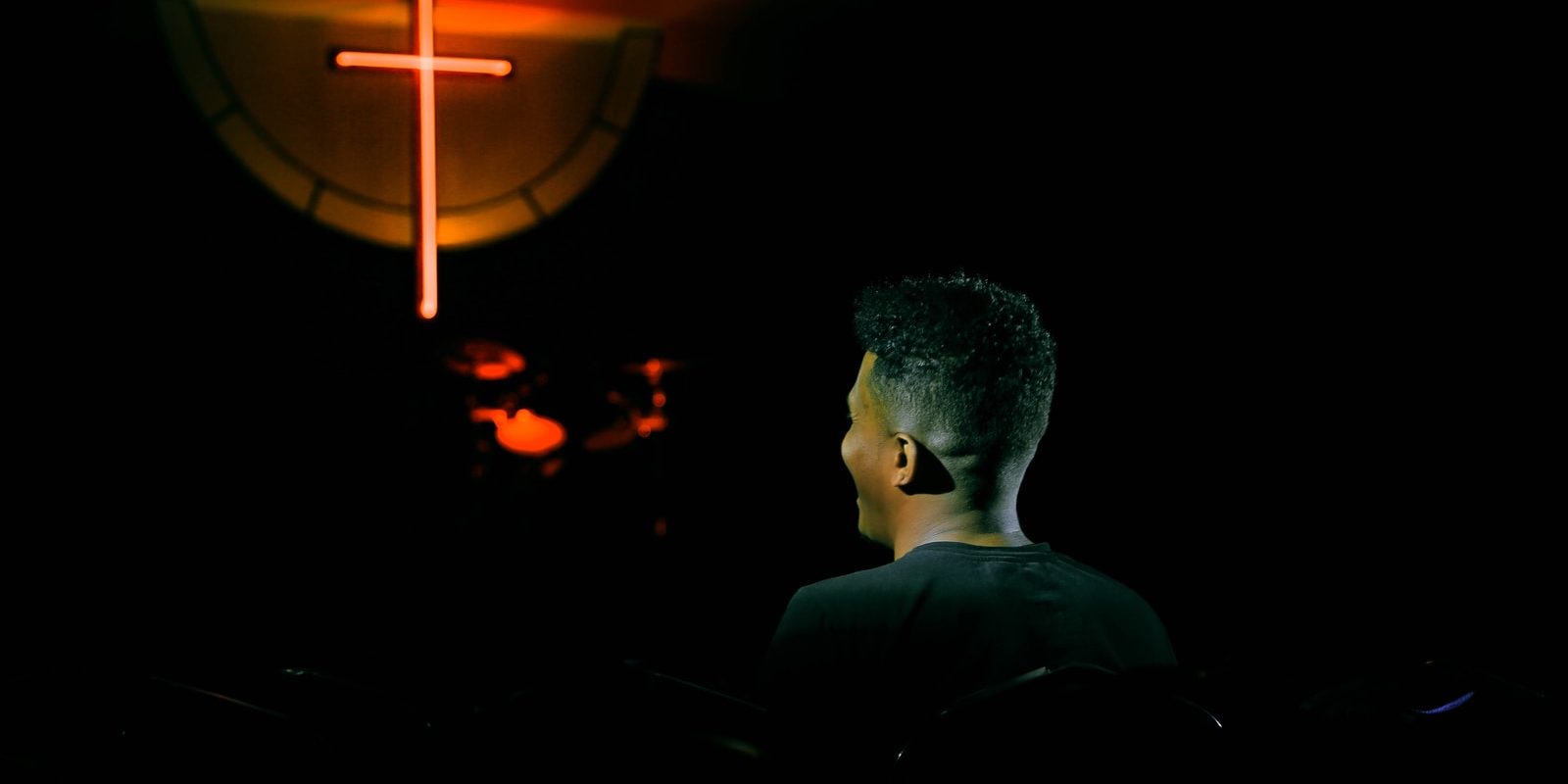 man in front of cross
