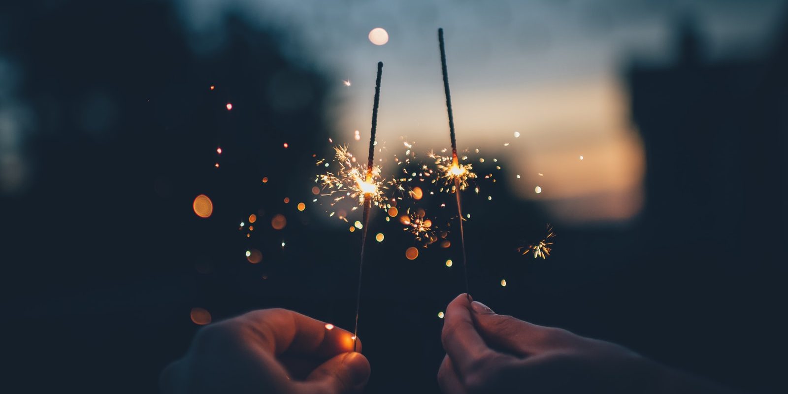 person holding fire cracker shallow focus photography